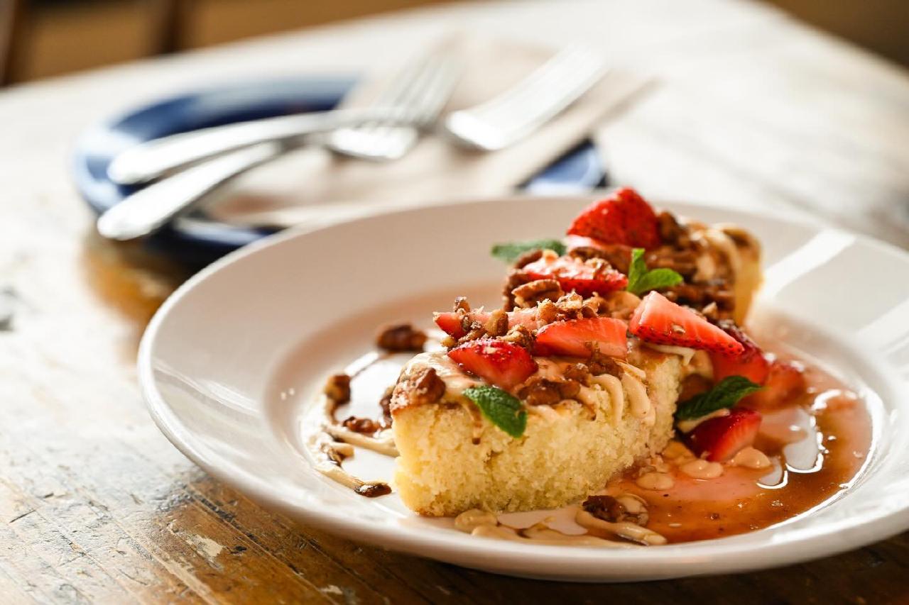 Brown butter cake with crème anglaise and strawberries